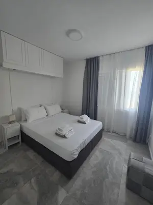 a bedroom with a large bed with white sheets at Lazuli Beachfront Sea View Ap 34 in Larnaka