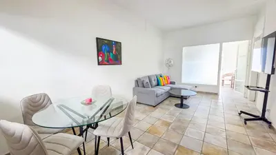 a living room with a glass table and chairs at Citycenter Comfy Apartment in Larnaka