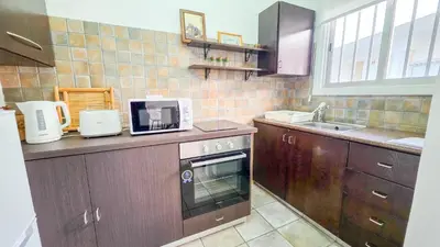 a kitchen with a sink and a stove top oven at Citycenter Comfy Apartment in Larnaka