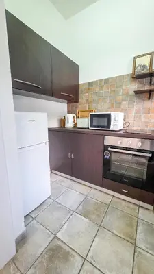 a kitchen with a stove and a microwave at Citycenter Comfy Apartment in Larnaka