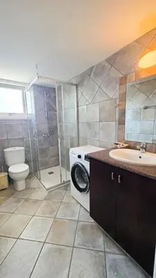 a bathroom with a washing machine and a sink at Citycenter Comfy Apartment in Larnaka
