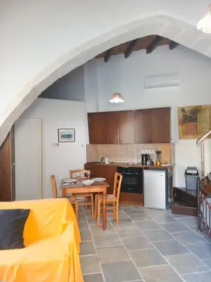 a kitchen and dining room with a table and chairs at Traditional Cozy Retreat in Skarinou