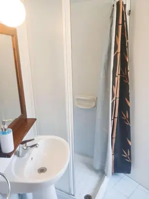 a bathroom with a sink and a shower at Traditional Cozy Retreat in Skarinou