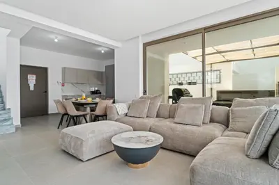 a living room with a couch and a table at St Nicholas Luxury 3-Bed Villa in Paralimni