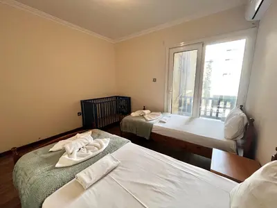 two beds in a room with a window at STAY Napa Oniro Apartment in Ayia Napa