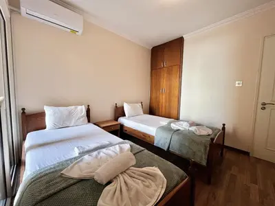a small room with two beds and a window at STAY Napa Oniro Apartment in Ayia Napa