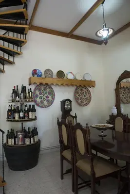 a room with a table and some plates on the wall at Marianna Mansion in Pachna