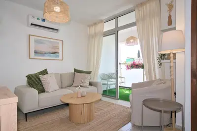 a living room with a couch and a table at Cosy Charming Balcony Suite in Nicosia