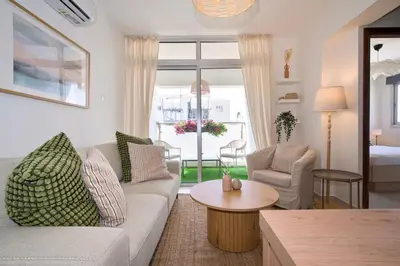 a living room with a couch and a table at Cosy Charming Balcony Suite in Nicosia