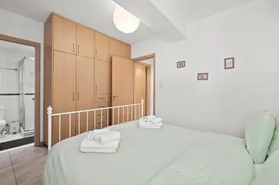 a bedroom with a large bed with towels on it at Giorgio Downtown 2 Bedroom Apartment in Larnaka