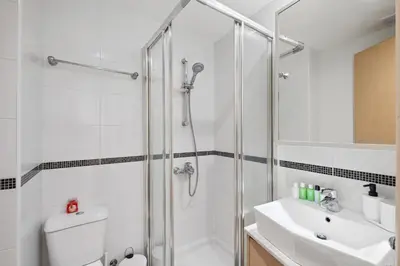 a bathroom with a shower and a toilet and a sink at Giorgio Downtown 2 Bedroom Apartment in Larnaka