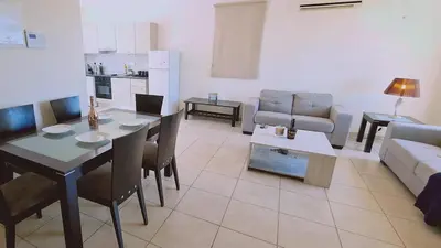 a living room with a table and a couch at STAY Sunny Bay Villa in Protaras