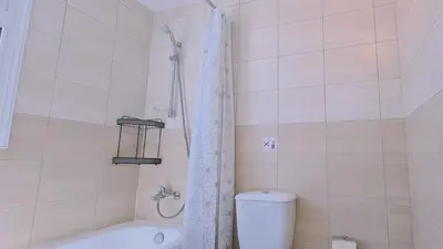 a bathroom with a tub and a toilet and a shower at STAY Sunny Bay Villa in Protaras