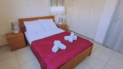 a bedroom with a bed with two towels on it at STAY Sunny Bay Villa in Protaras