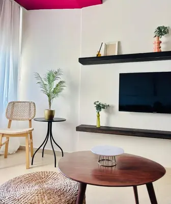 a living room with a tv and a coffee table at Larnaca Seaview Apartment with pool & parking in Larnaka
