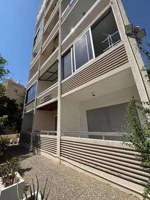 a building with large windows on the side of it at Larnaca Seaview Apartment with pool & parking in Larnaka