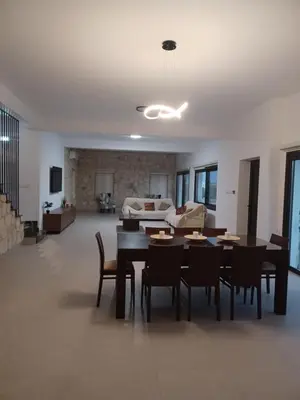a living room with a table and chairs and a couch at Melissa Hills in Ayia Napa