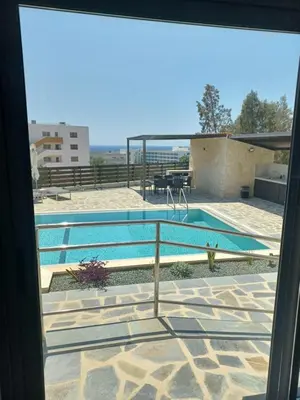a view of a swimming pool from a window at Melissa Hills in Ayia Napa
