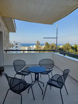 a patio with four chairs and a table on a balcony at Melissa Hills in Ayia Napa