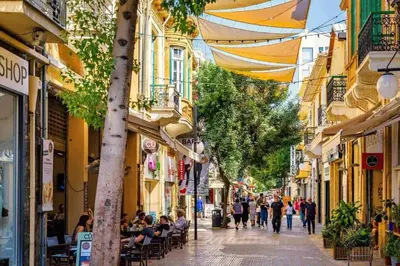 a group of people walking down a street with buildings at Central Penthouse Sky Suite in Nicosia