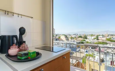 a kitchen with a view of a city from a balcony at Central Penthouse Sky Suite in Nicosia