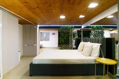 a bedroom with a large bed with a wooden ceiling at City Centre Studio Eleftheria Sq in Nicosia