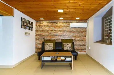 a living room with a couch and a brick wall at City Centre Studio Eleftheria Sq in Nicosia