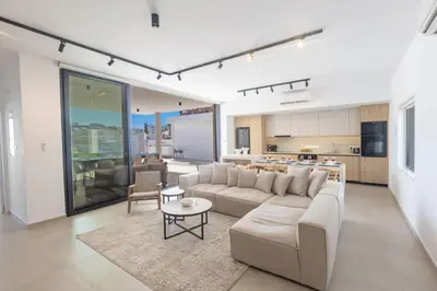a living room with a couch and a table at Ayia Napa Orea Villa OR8 in Ayia Napa