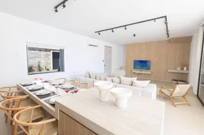 a kitchen and living room with a table and chairs at Ayia Napa Orea Villa OR8 in Ayia Napa
