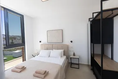 a bedroom with a bed with two towels on it at Ayia Napa Orea Villa OR8 in Ayia Napa
