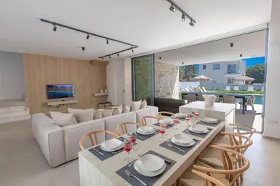 a dining room and living room with a table and chairs at Ayia Napa Orea Villa OR8 in Ayia Napa
