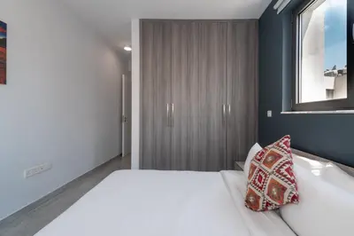 a bedroom with a large white bed with a window at Luxury Modern Larnaca Central in Larnaka
