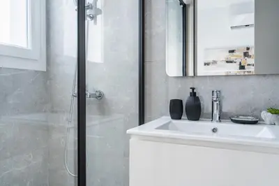 a white bathroom with a shower and a sink at Doria 2-Bedroom Apartment & Balcony in Larnaca in Aradhippou