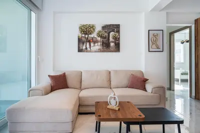 a living room with a couch and a table at Doria 2-Bedroom Apartment & Balcony in Larnaca in Aradhippou