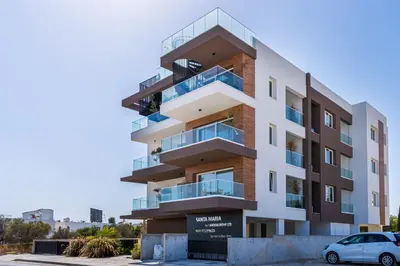 a building with a car parked in front of it at Doria 2-Bedroom Apartment & Balcony in Larnaca in Aradhippou