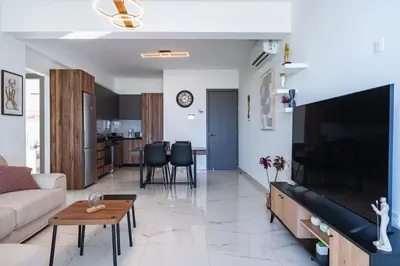 a living room with a couch and a tv at Doria 2-Bedroom Apartment & Balcony in Larnaca in Aradhippou