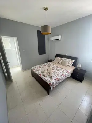 a bedroom with a bed and a blue wall at Azure Waves House in Voroklini