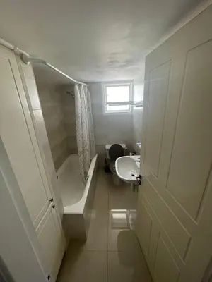 a bathroom with a tub and a toilet and a sink at Azure Waves House in Voroklini