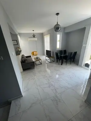 a large living room with a table and chairs at Azure Waves House in Voroklini