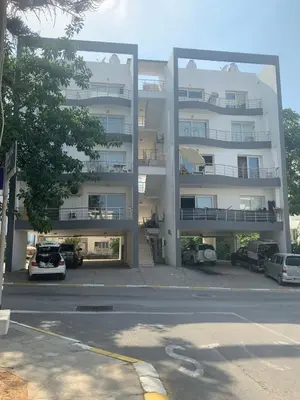 a large apartment building with cars parked in a parking lot at Flat in Kyrenia, Cyprus in Kérynia