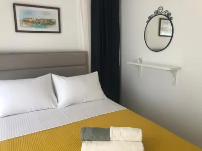 a bedroom with a bed with a mirror on the wall at Flat in Kyrenia, Cyprus in Kérynia