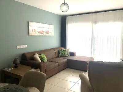 a living room with a couch and a table at Flat in Kyrenia, Cyprus in Kérynia