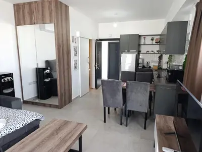 a kitchen and living room with a table and chairs at Deja Blue Apartments, North Cyprus