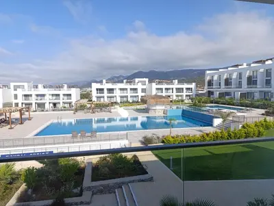 an apartment complex with a swimming pool and buildings at Deja Blue Apartments, North Cyprus