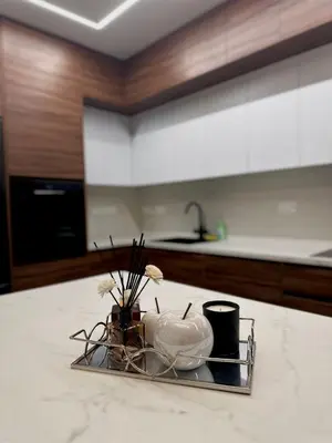 a tray with flowers and a vase on a counter in a kitchen at Mall View Modern PentHouse in Larnaka