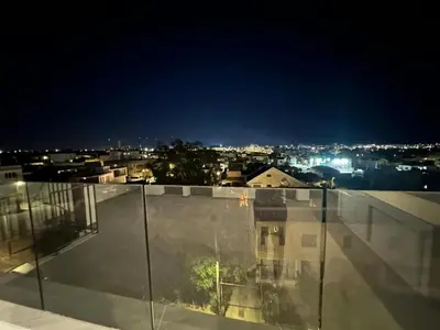 a view of a city at night from a building at Mall View Modern PentHouse in Larnaka