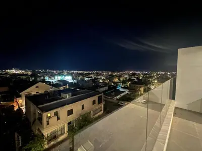 a view of a city at night from a building at Mall View Modern PentHouse in Larnaka