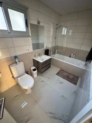 a bathroom with a toilet and a sink and a tub at Bachelor Court 1 in Ayia Napa