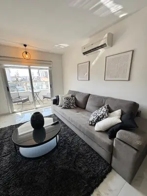 a living room with a couch and a table at Bachelor Court 1 in Ayia Napa