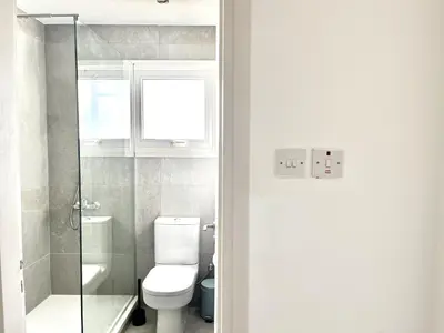 a bathroom with a toilet and a glass shower at STAY Almyra House in Protaras